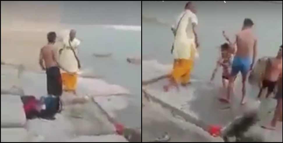 Pandit ji beat boys on banks of river Ganga in Rishikesh