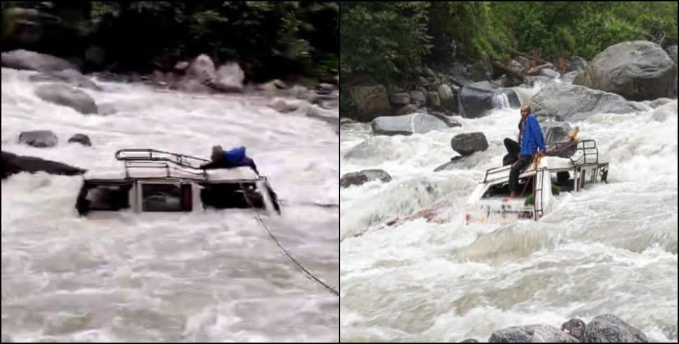 Vehicle fell from road into overflowing river
