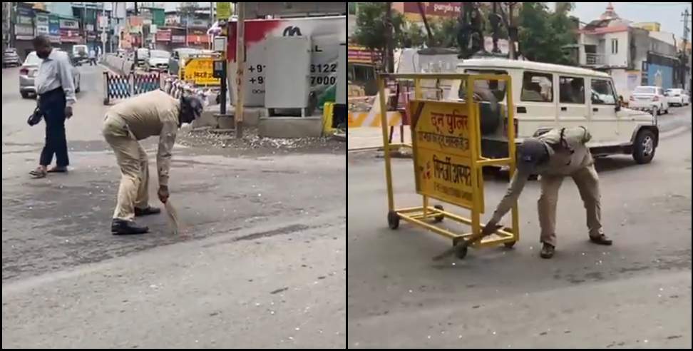 dehradun police: Policeman sweeps the road in Dehradun