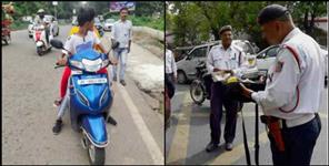 image: dehradun traffic police without helmet challan