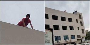 image: young man climbed high building in haldwani