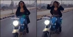 image: girl bike stunt without helmet and challan in dehradun