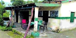 image: Roof of school rests on two beams in Chamoli