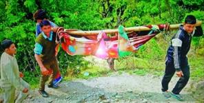 image: Villagers of bijnu walk 6 km to hospital for sick man