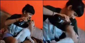 image: Girl gives beer to dog in Dehradun