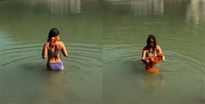 image: Foreign woman bathes in the Ganges in bikini