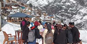image: Students study in open amid snowfall in MLA village