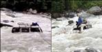 Vehicle fell from road into overflowing river