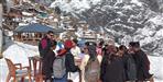 Students study in open amid snowfall in MLA village